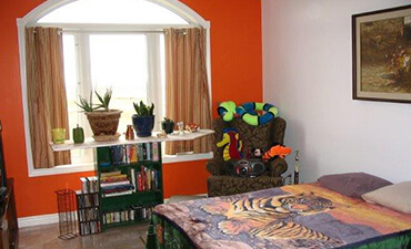 a bedroom with an orange wall